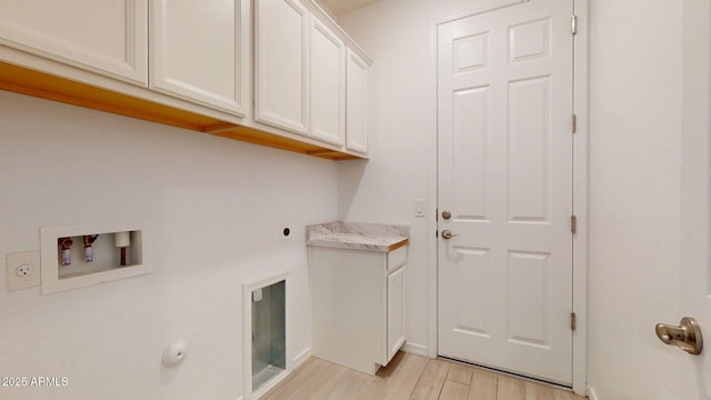 laundry area with light wood-style floors, hookup for a washing machine, baseboards, cabinet space, and hookup for an electric dryer