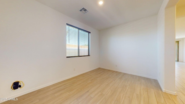spare room featuring recessed lighting, baseboards, visible vents, and light wood finished floors