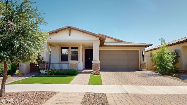 view of front of home with a porch, a tiled roof, decorative driveway, an attached garage, and stucco siding