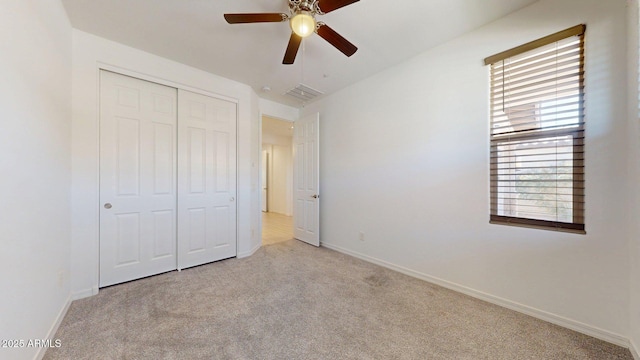 unfurnished bedroom featuring a closet, baseboards, a ceiling fan, and carpet flooring