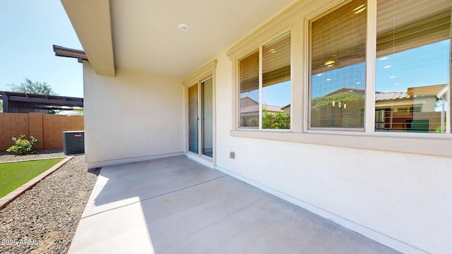 view of patio / terrace with central air condition unit and fence