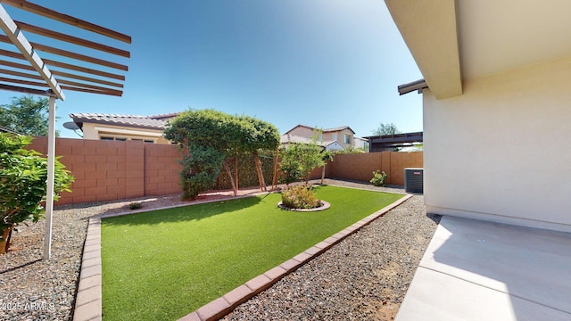 view of yard featuring a fenced backyard, cooling unit, and a patio area