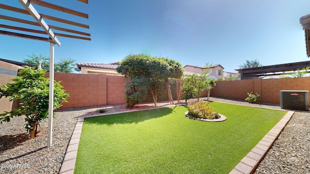 view of yard with a fenced backyard, a pergola, and central AC