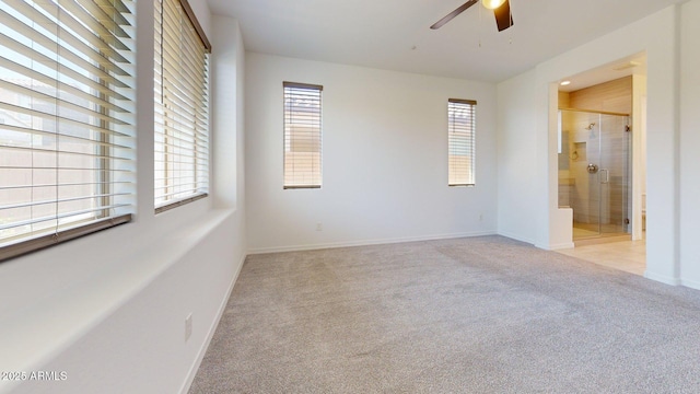 unfurnished bedroom with baseboards, light carpet, and connected bathroom