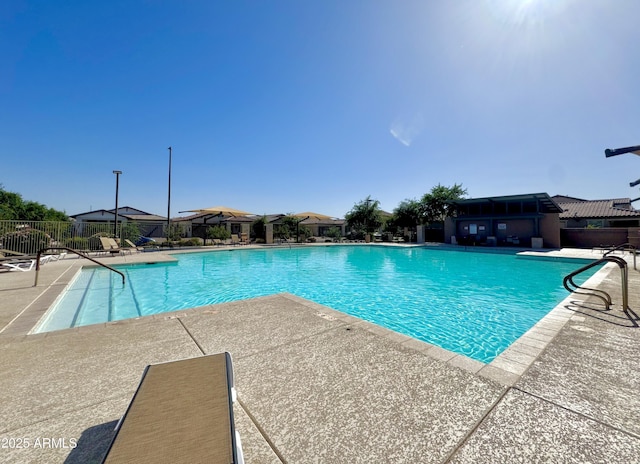 community pool featuring a patio and fence