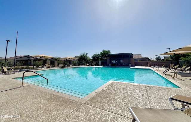 pool featuring fence and a patio