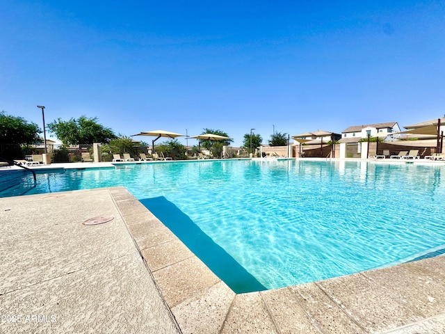 pool with fence and a patio