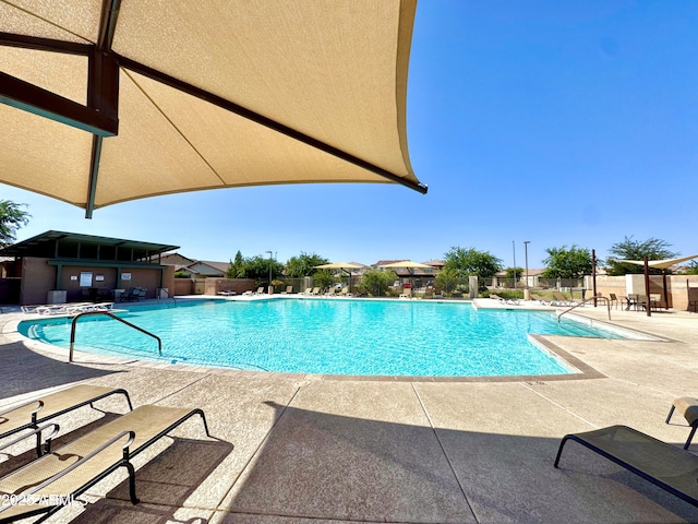 pool featuring fence and a patio area