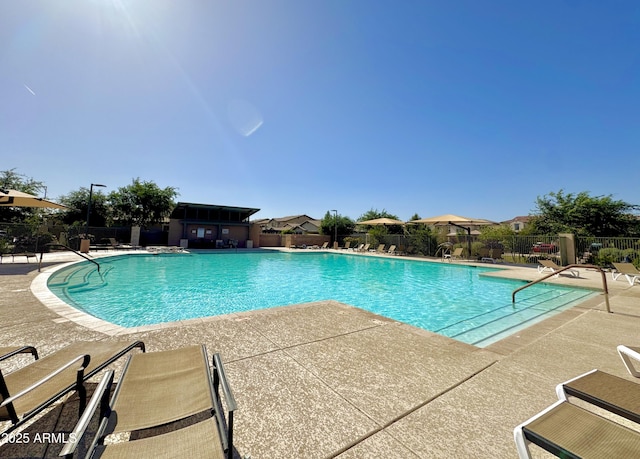 pool with fence and a patio