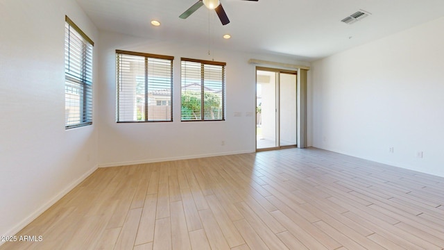 empty room with light wood-style flooring, a ceiling fan, baseboards, recessed lighting, and visible vents