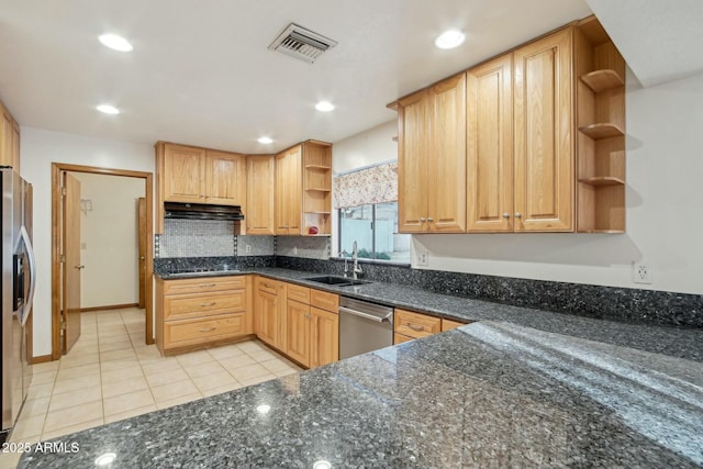 kitchen featuring light tile patterned flooring, appliances with stainless steel finishes, sink, and dark stone countertops