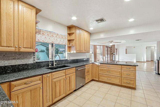 kitchen with sink, light tile patterned floors, dishwasher, kitchen peninsula, and dark stone counters