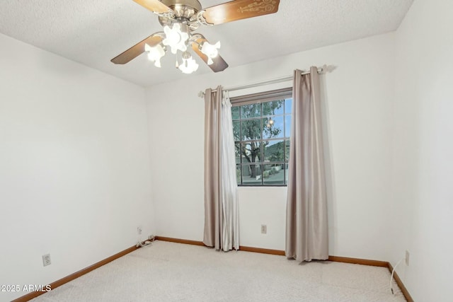 spare room featuring light carpet, ceiling fan, and a textured ceiling