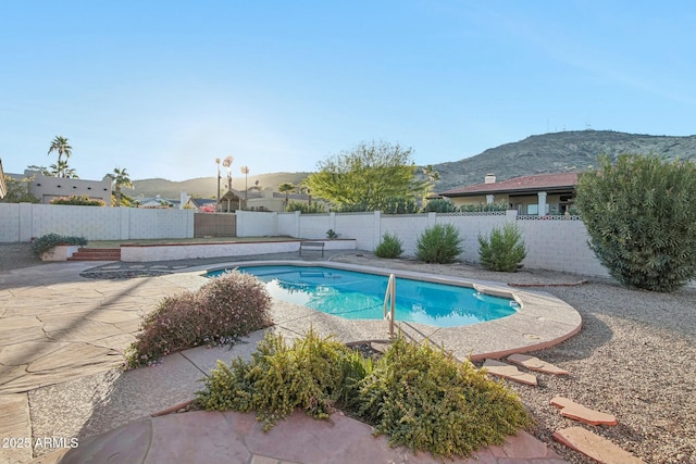 view of swimming pool featuring a mountain view and a patio area