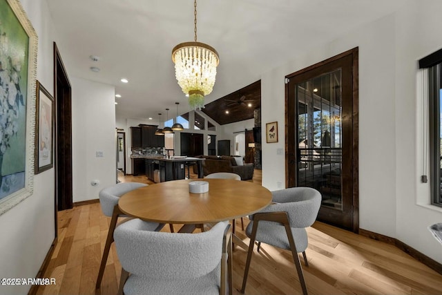 dining space with a chandelier, light wood-type flooring, baseboards, and recessed lighting