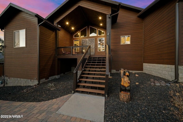 exterior entry at dusk with crawl space