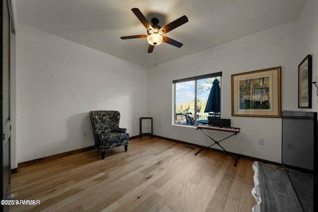 unfurnished room with light wood-style floors, ceiling fan, and baseboards