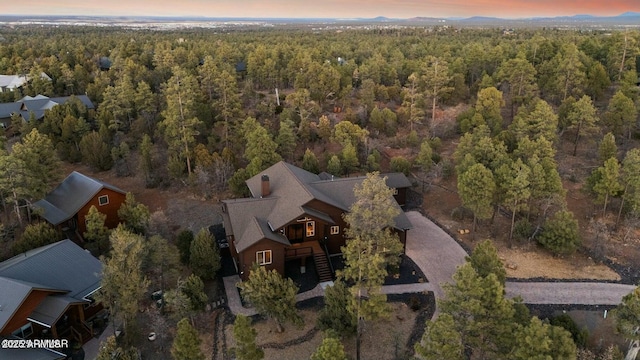 birds eye view of property with a wooded view