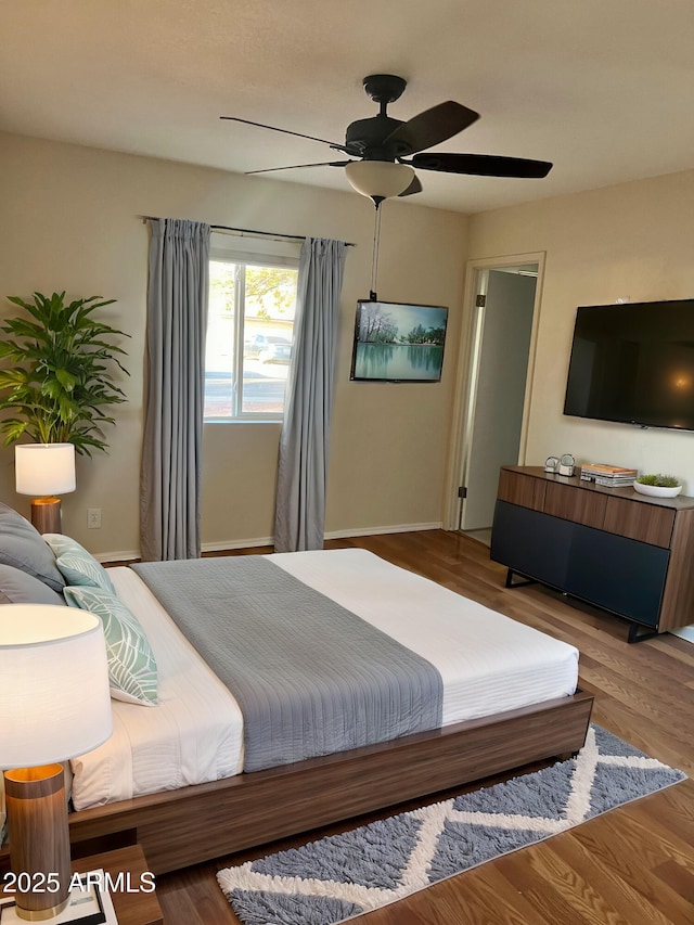 bedroom with wood-type flooring and ceiling fan