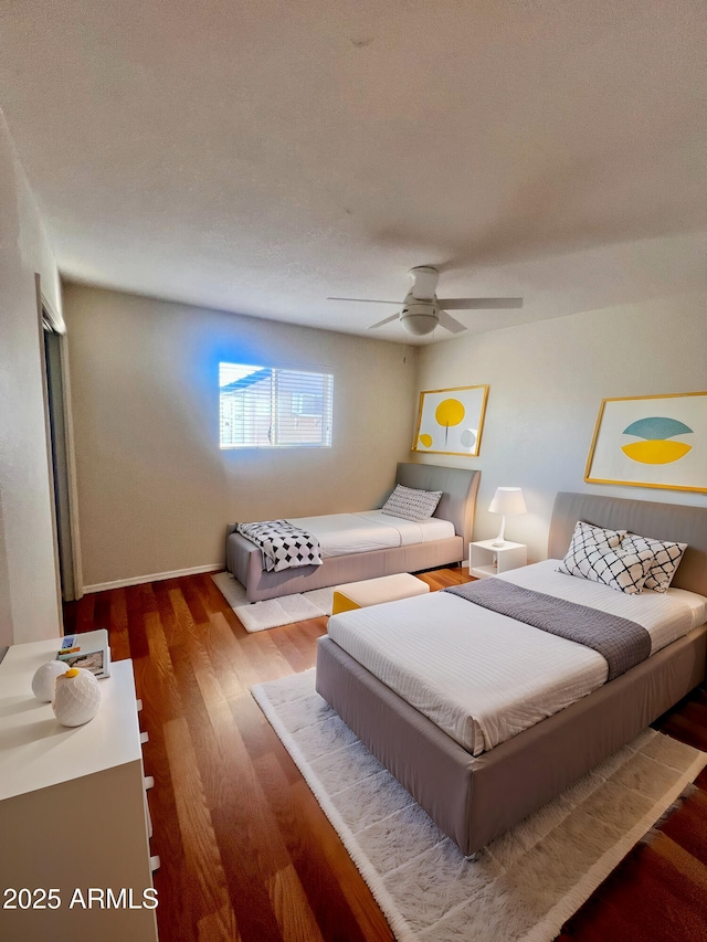 bedroom featuring hardwood / wood-style flooring and ceiling fan