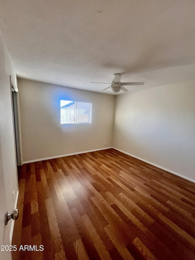 empty room featuring dark hardwood / wood-style floors and ceiling fan