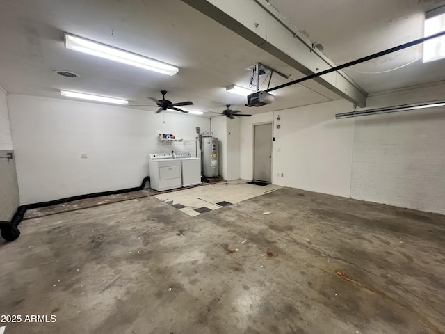 garage featuring a garage door opener, washer and clothes dryer, and water heater