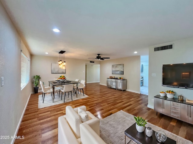 living room with hardwood / wood-style floors and ceiling fan