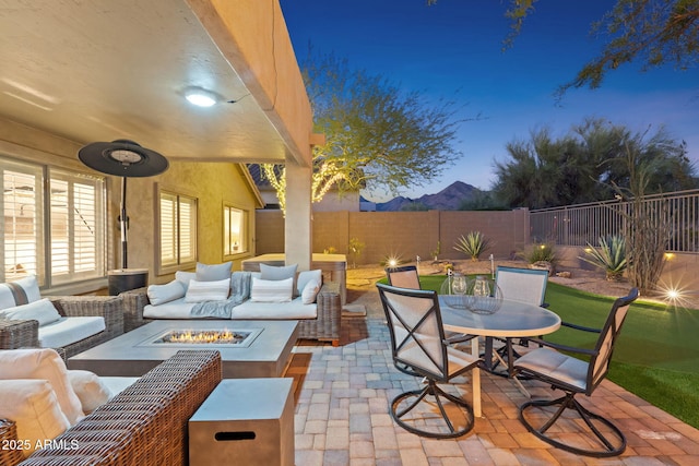 view of patio / terrace with an outdoor living space with a fire pit, outdoor dining area, and a fenced backyard