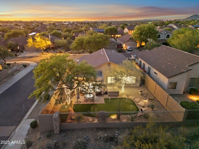 aerial view at dusk featuring a residential view