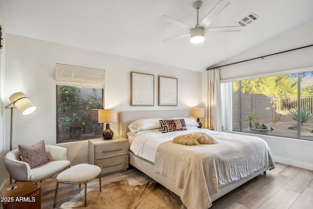 bedroom with a ceiling fan, visible vents, wood finished floors, and lofted ceiling