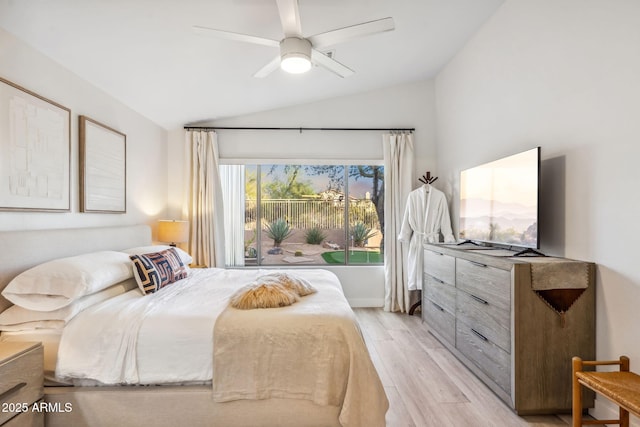 bedroom with light wood finished floors, ceiling fan, and lofted ceiling