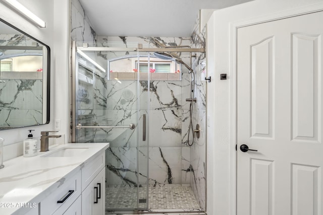 full bathroom featuring a healthy amount of sunlight, vanity, and a marble finish shower