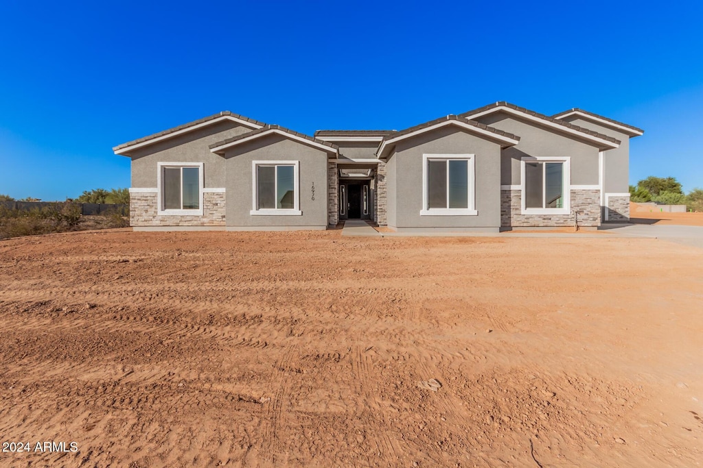 16970 W Baker St, Surprise, AZ 85387 - back of property with stucco siding, a tiled roof, and stone siding