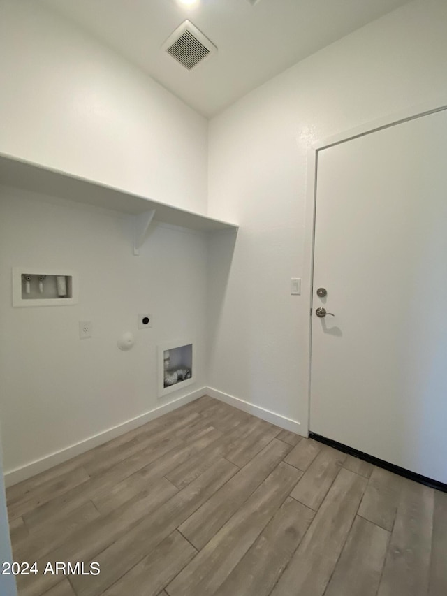 laundry room with washer hookup, gas dryer hookup, light wood-type flooring, and hookup for an electric dryer