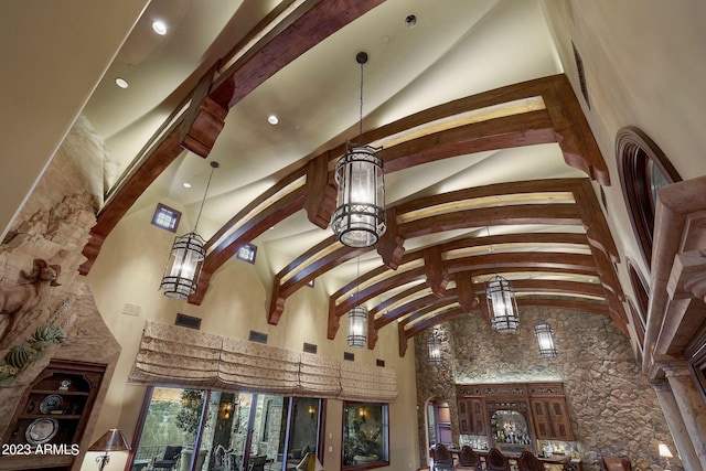 interior details with an inviting chandelier and beamed ceiling