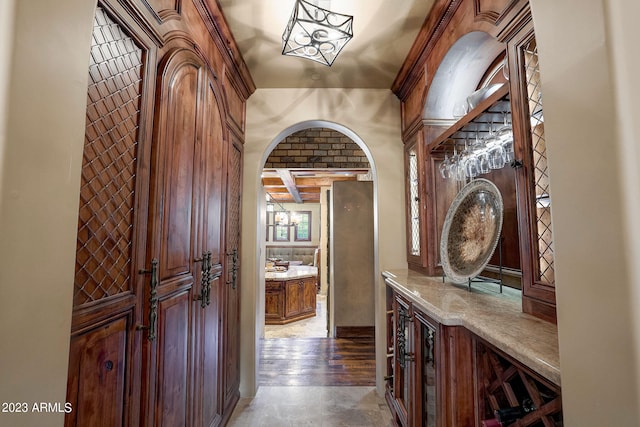 wine room featuring dark wood-type flooring and bar area