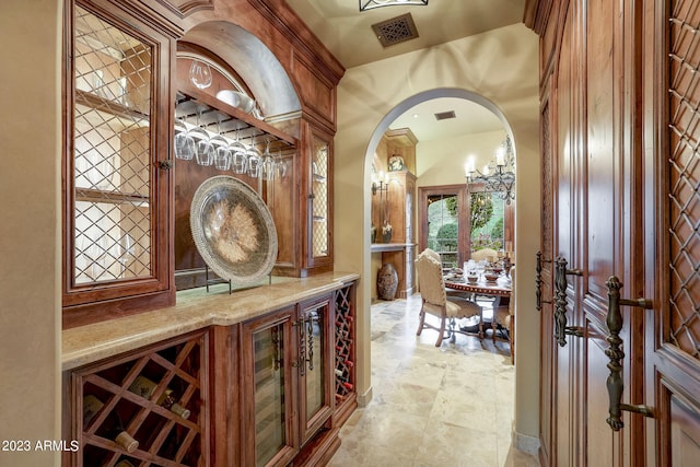 wine cellar with light tile flooring and a notable chandelier