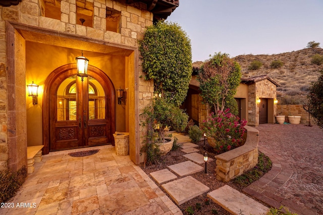 exterior entry at dusk featuring french doors