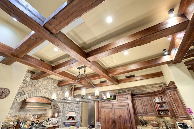 interior details featuring coffered ceiling, beamed ceiling, and a fireplace