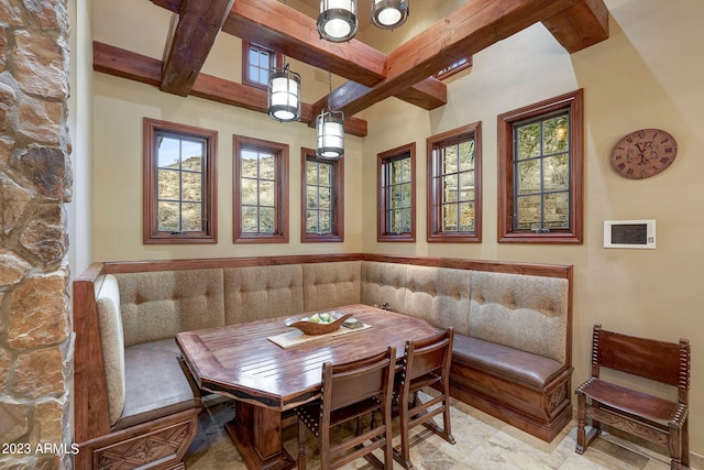 dining space featuring a chandelier, beamed ceiling, and light tile floors