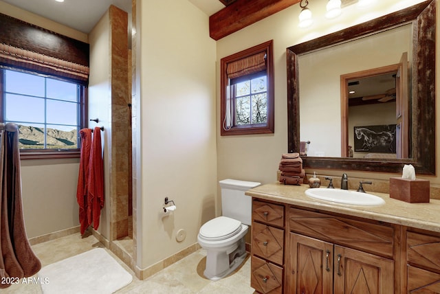 bathroom with toilet, a healthy amount of sunlight, vanity, and tile flooring