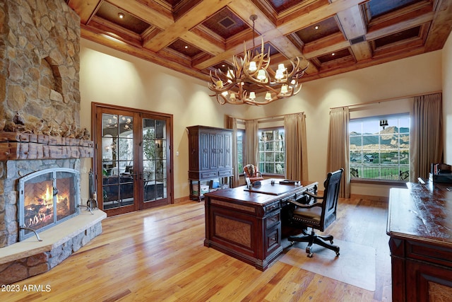 office featuring coffered ceiling, light hardwood / wood-style floors, a notable chandelier, beam ceiling, and french doors