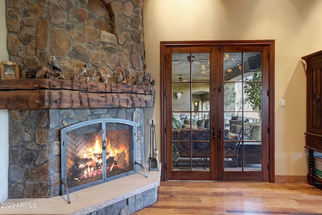 interior space with light hardwood / wood-style flooring, french doors, and a fireplace