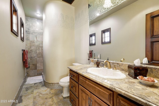 bathroom featuring tile floors, toilet, and vanity