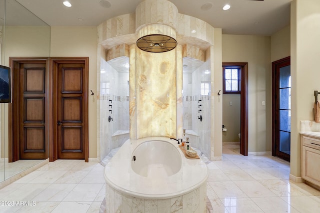 bathroom featuring vanity, tile flooring, and shower with separate bathtub