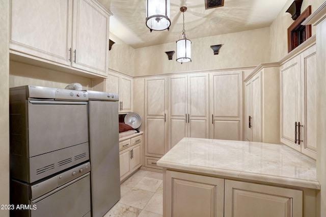 kitchen featuring light tile floors, light stone countertops, and decorative light fixtures