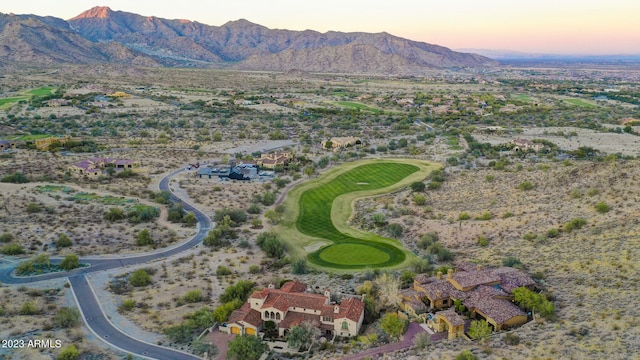 aerial view at dusk featuring a mountain view