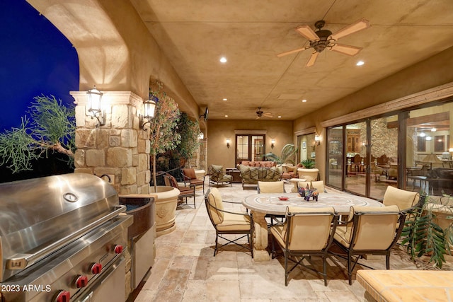 patio terrace at twilight featuring a grill, ceiling fan, an outdoor hangout area, and area for grilling