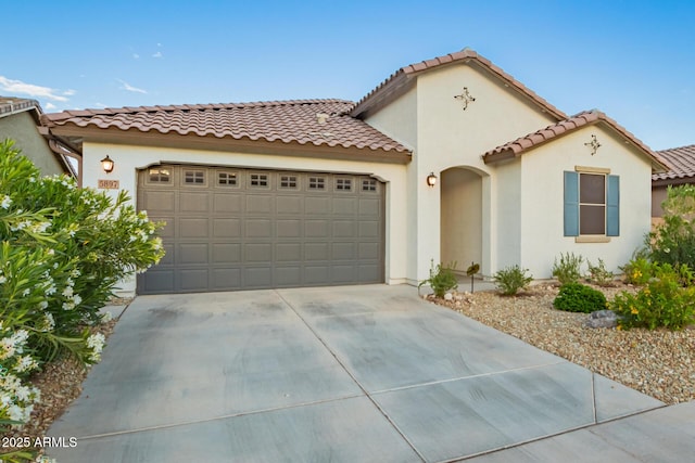 5897 N 195th Dr, Litchfield Park, AZ 85340 - mediterranean / spanish-style house featuring driveway, a garage, a tiled roof, and stucco siding