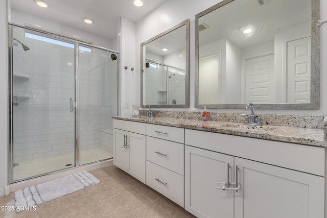 5897 N 195th Dr, Litchfield Park, AZ 85340 - bathroom featuring a shower stall, tile patterned flooring, double vanity, and recessed lighting